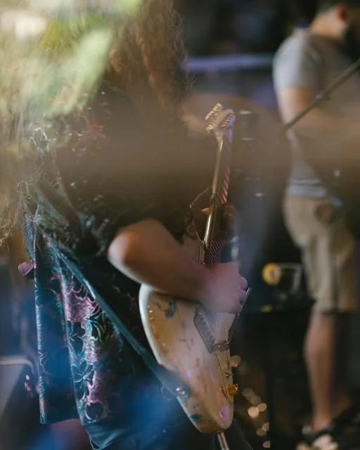 A guitar being played during a Jazz Odyssey session.